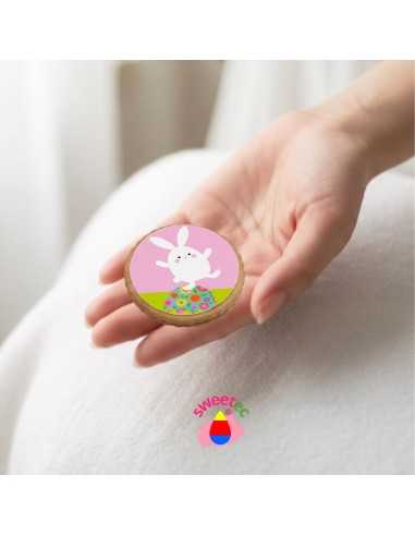 6.5cm chocolate biscuit with edible print of Easter bunny faces on cupcakes, held in hand. Ideal for Easter treats or gifts.