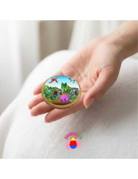 6.5cm chocolate biscuit with edible print of a colorful dinosaur scene, held in hand. Ideal for children's parties.