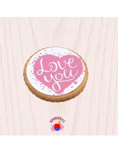 6.5cm chocolate biscuit with edible print of a pink heart with the text Love You. Shown on a light wooden background. Ideal for