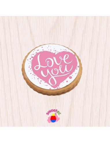 6.5cm chocolate biscuit with edible print of a pink heart with the text Love You. Shown on a light wooden background. Ideal for